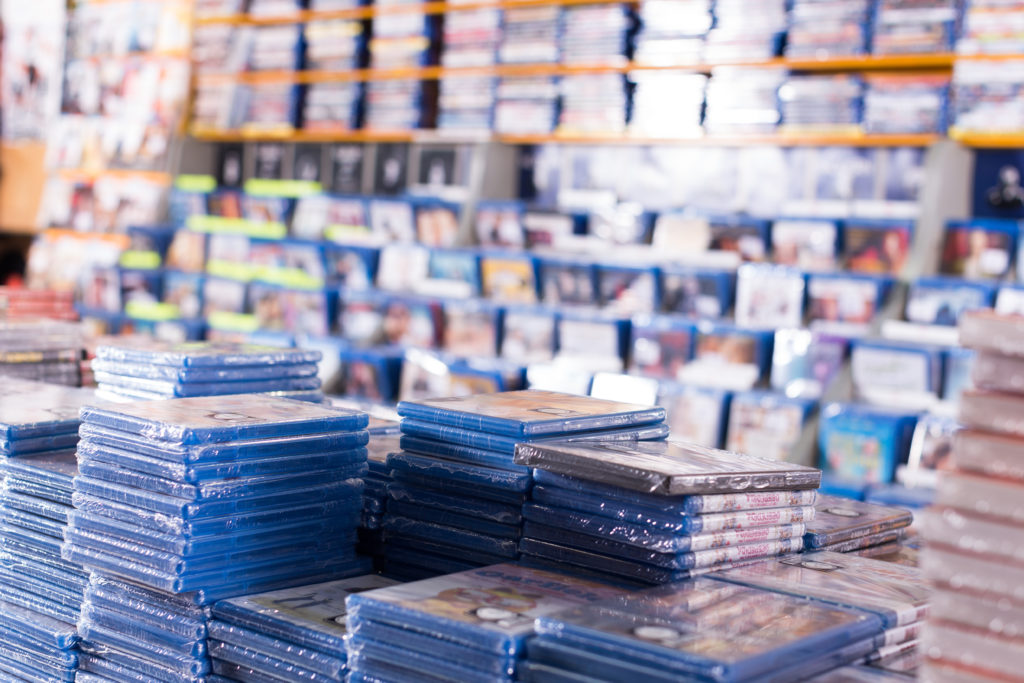 CDs and DVDs on piles at store